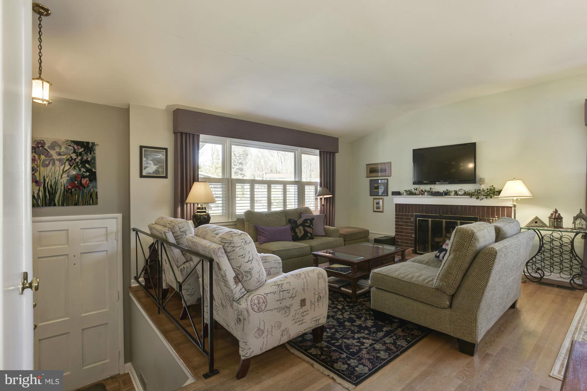 6705 Maxalea Road Baltimore, MD 21239 - Photo 3 of 30 a living room with furniture and a flat screen tv