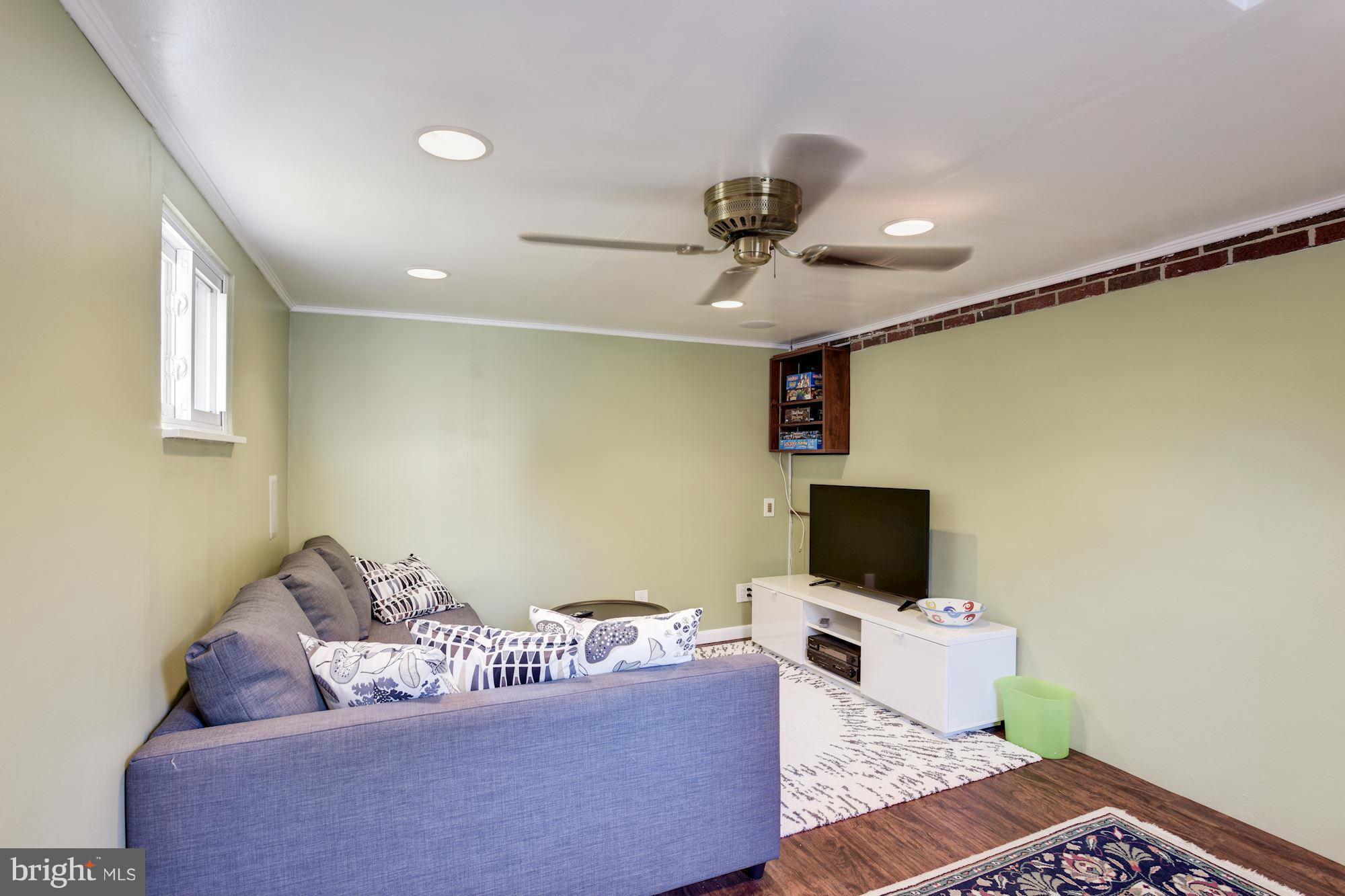 6705 Maxalea Road Baltimore, MD 21239 - Photo 22 of 30 a living room with furniture and a flat screen tv