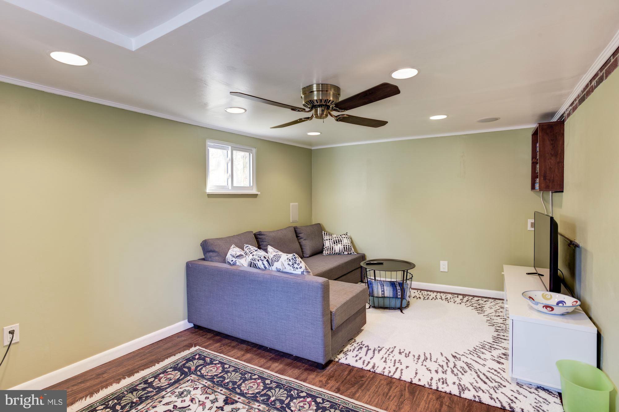 6705 Maxalea Road Baltimore, MD 21239 - Photo 23 of 30 a living room with furniture and a flat screen tv