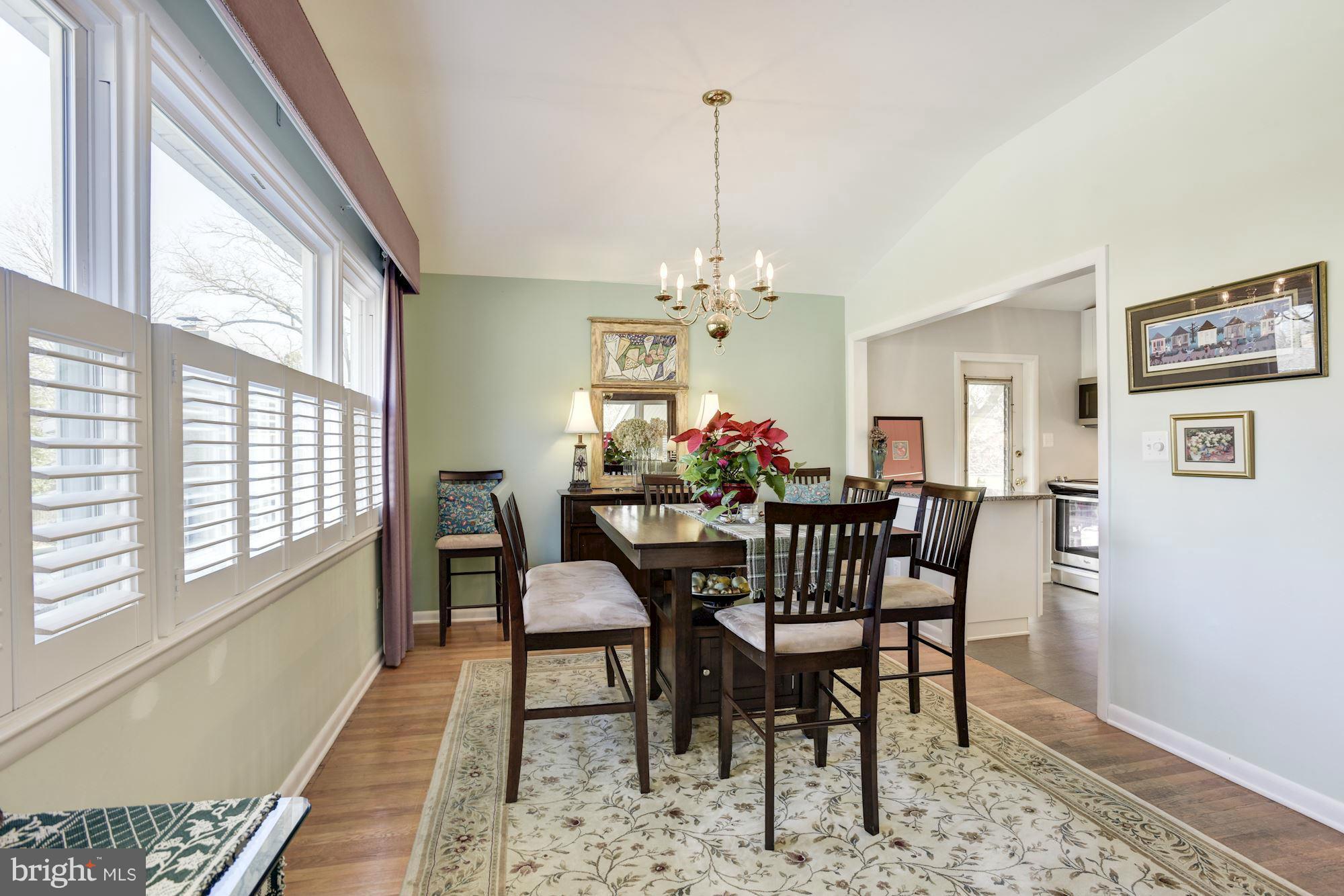 6705 Maxalea Road Baltimore, MD 21239 - Photo 7 of 30 a dining room with furniture a chandelier and wooden floor