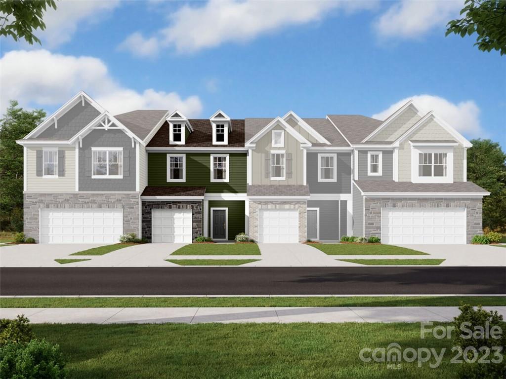 6039 Rizer Drive Charlotte, NC 28269 - Photo 2 of 5 a front view of a house with a garden and lake view