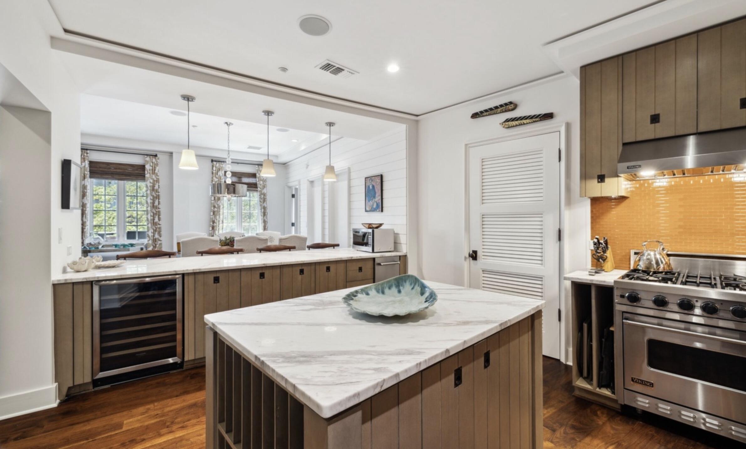78 North Barrett Square, Unit 4 Inlet Beach, FL 32461 - Photo 12 of 36 a kitchen with stainless steel appliances granite countertop a table chairs and stove