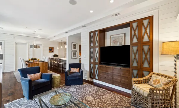 a bedroom with furniture and a flat screen tv