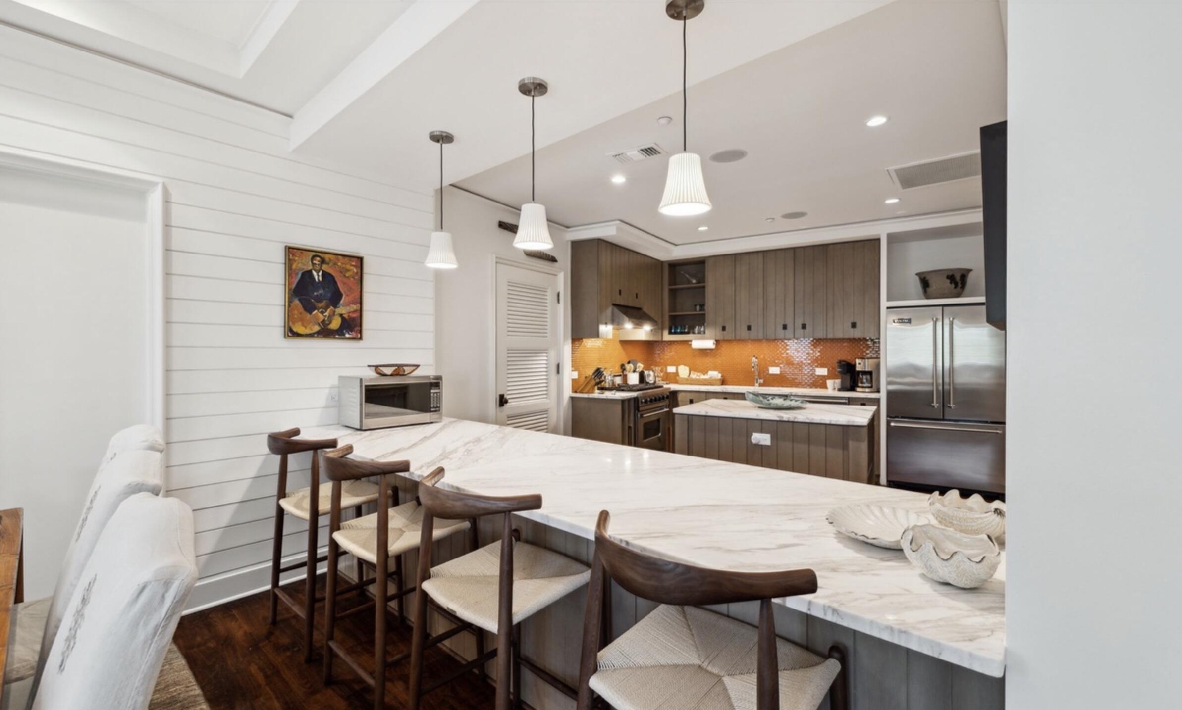 78 North Barrett Square, Unit 4 Inlet Beach, FL 32461 - Photo 4 of 36 a kitchen with stainless steel appliances kitchen island granite countertop a dining table chairs and a refrigerator