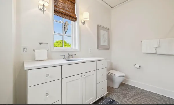 a kitchen with granite countertop a sink a stove and cabinets