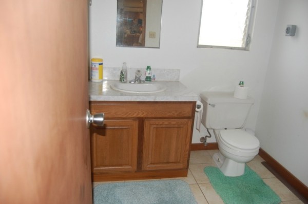 6224 Holio Road Kapaa, HI 96746 - Photo 5 of 14 a bathroom with a sink a toilet and a mirror