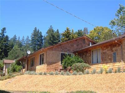 1205 Rim Of The Redwoods Road Sebastopol, CA 95472 - Photo 1 of 12 a view of a house with a tree in the background