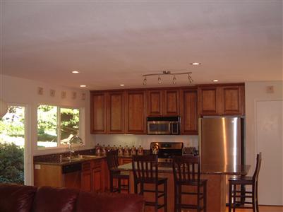 1205 Rim Of The Redwoods Road Sebastopol, CA 95472 - Photo 9 of 12 a kitchen with stainless steel appliances a refrigerator and wooden cabinets