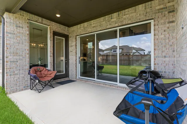 an aerial view of a house with a garden and lake view