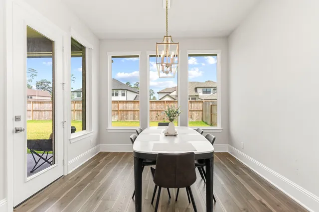 a kitchen with a sink a stove and chairs