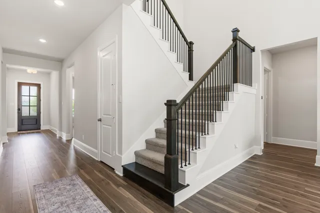 a large kitchen with kitchen island a large counter space a sink stainless steel appliances and cabinets