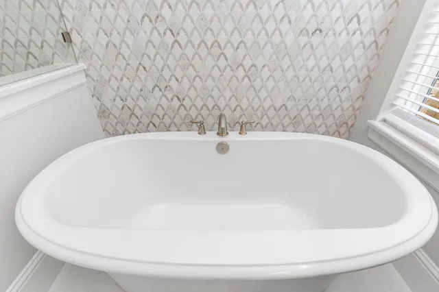 a bathroom with a granite countertop sink a toilet and bathtub