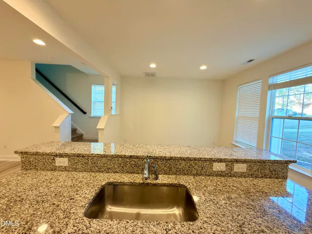 a view of kitchen with wooden floor and electronic appliances