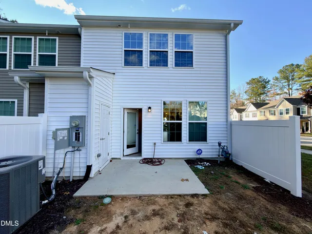 a view of a yard with an tree and a wooden fence