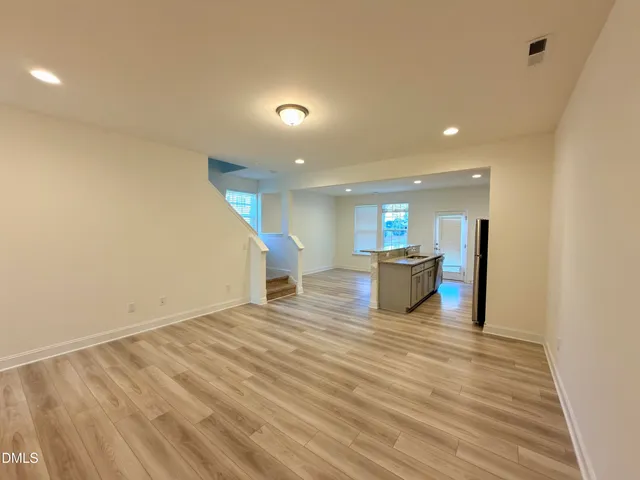 a kitchen with granite countertop a refrigerator and a sink