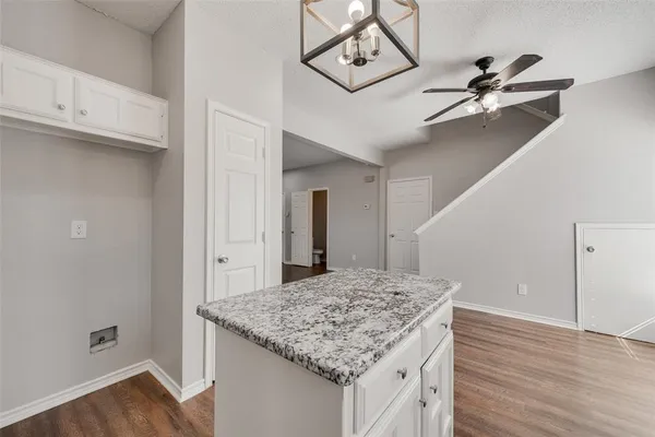 a kitchen with kitchen island a counter top space and wooden floor