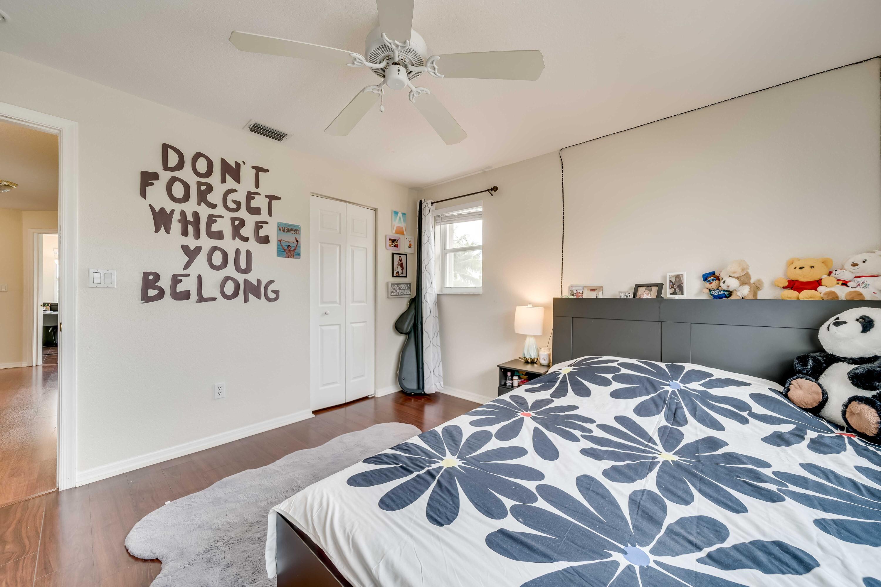 16738 Diamond Drive Weston, FL 33331 - Photo 26 of 38 a bedroom with a bed and a chandelier