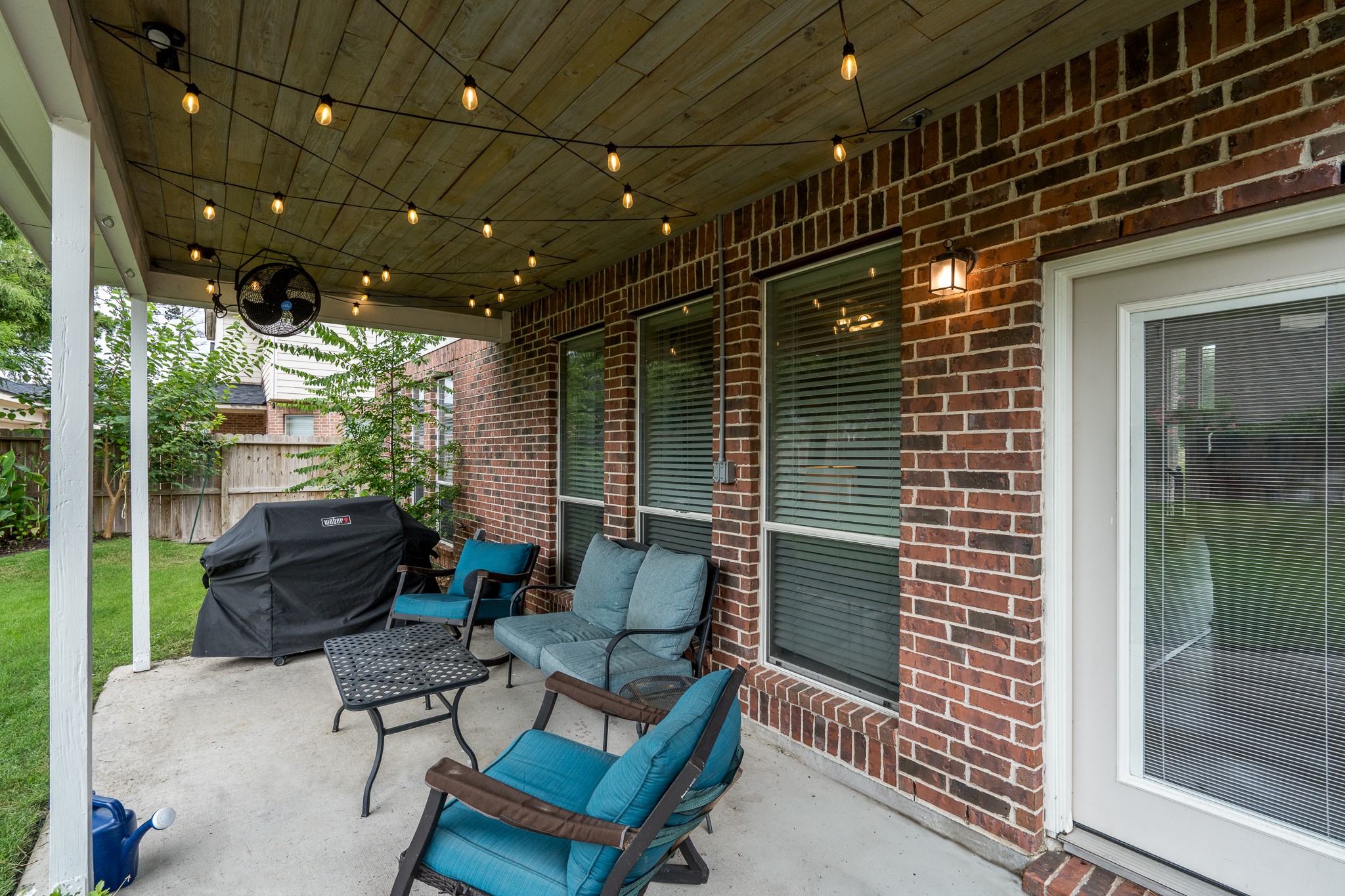 907 Colorado Springs Court Spring, TX 77373 - Photo 29 of 34 Check out this great covered patio featuring a custom wood-plank ceiling, outdoor fan, and ample space for relaxing or entertaining.