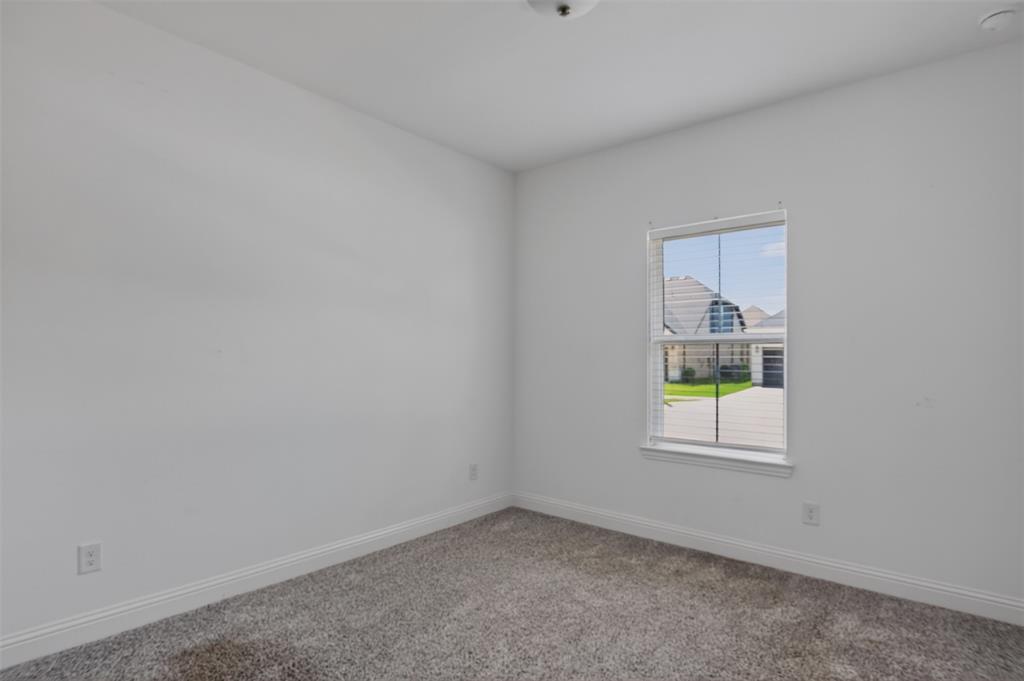 845 Ranchland Road Justin, TX 76247 - Photo 6 of 22 an empty room with windows