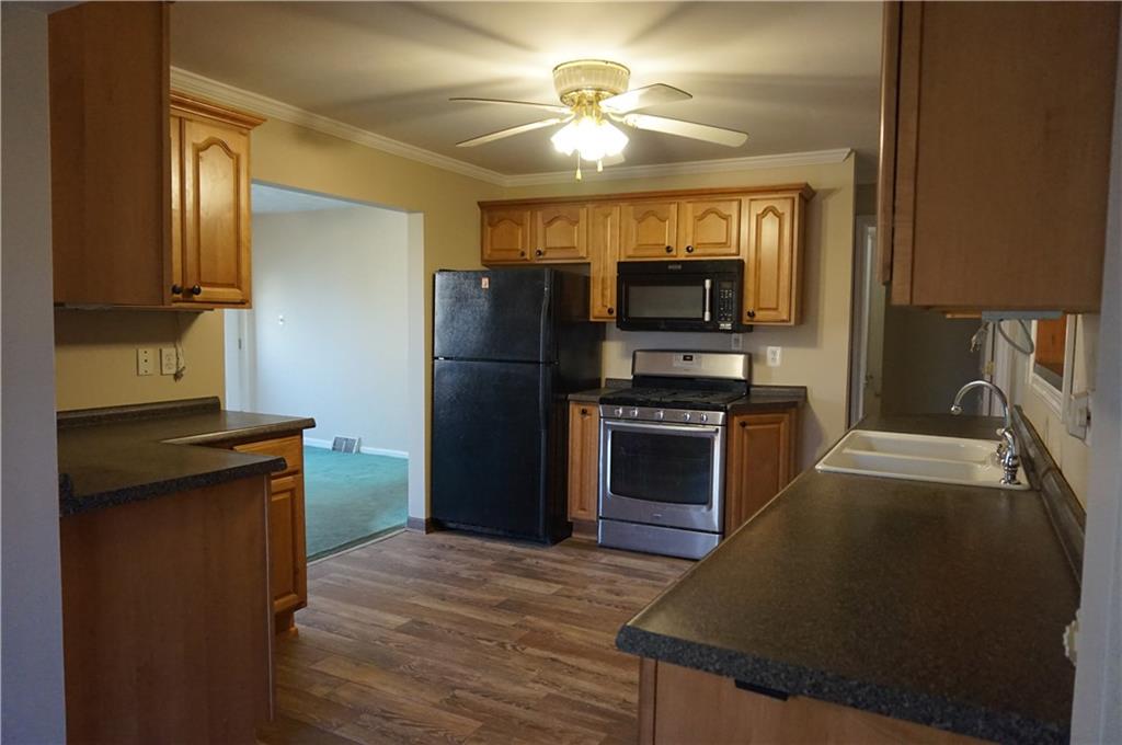 12 Tidball Road Pittsburgh, PA 15205 - Photo 3 of 14 UPDATED KITCHEN WITH OAK CABINETS AND CERAMIC TILE FLOORING, GAS STOVE, BUILT IN MICROWAVE AND REFRIGERATOR