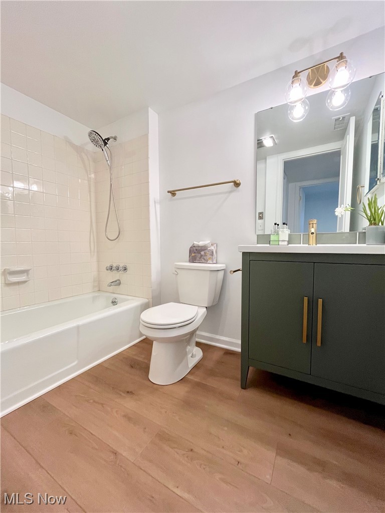 22701 Center Ridge Road, Unit 201 Rocky River, OH 44116 - Photo 20 of 37 Full bathroom with wood-type flooring, toilet, vanity, and tiled shower / bath