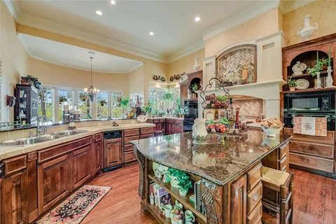 a view of a dining room with furniture a chandelier and wooden floor