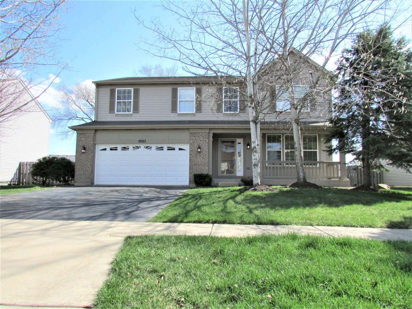 10123 Ashley Street Huntley, IL 60142 - Photo 1 of 33 a front view of a house with a yard and garage
