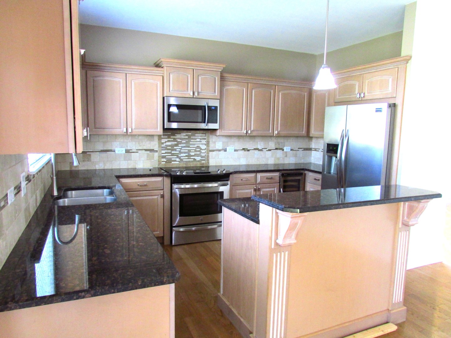 10123 Ashley Street Huntley, IL 60142 - Photo 2 of 33 a kitchen with stainless steel appliances granite countertop a sink a stove top oven a counter space and cabinets