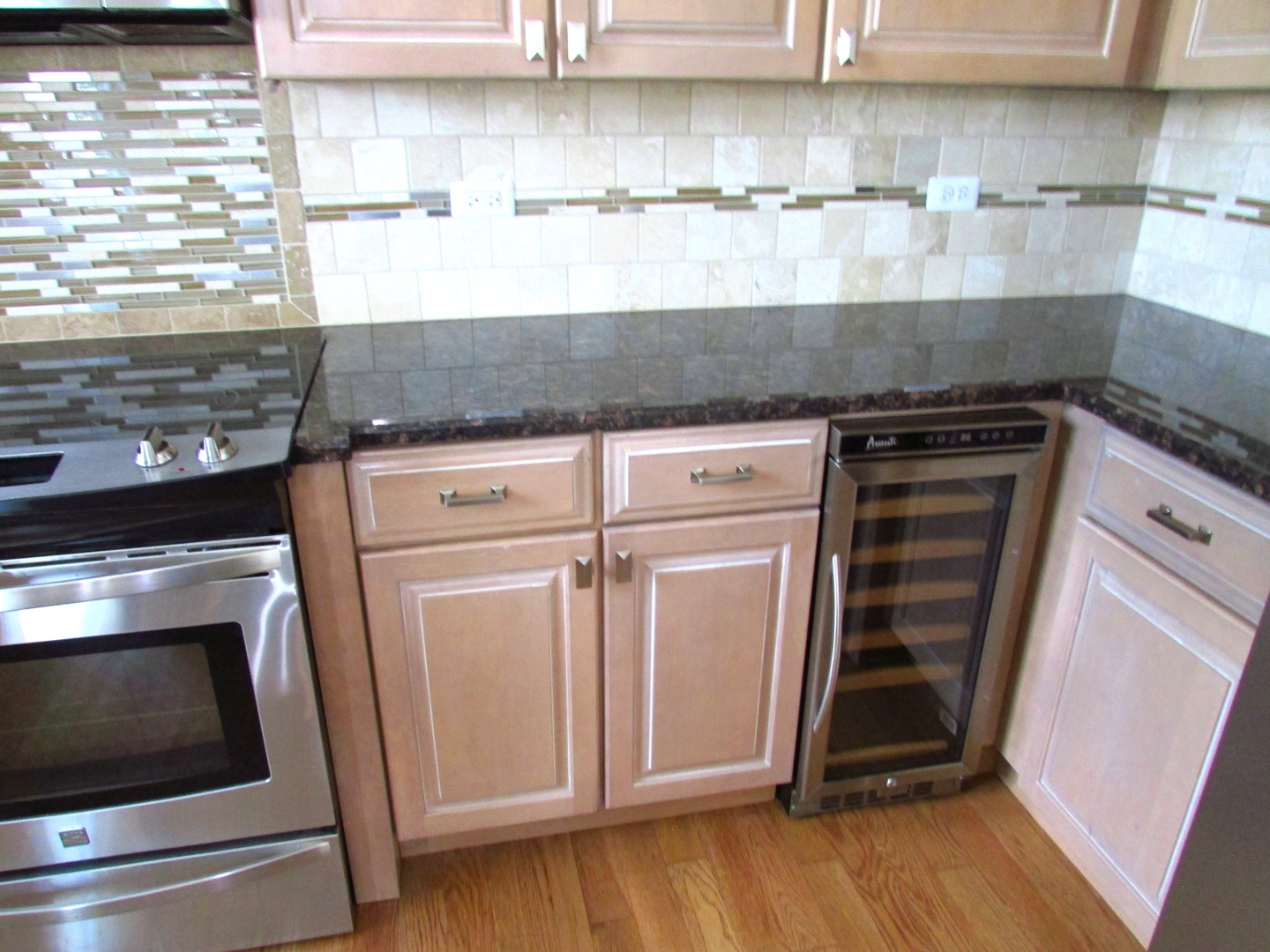 10123 Ashley Street Huntley, IL 60142 - Photo 4 of 33 a kitchen with stainless steel appliances granite countertop a stove and a microwave