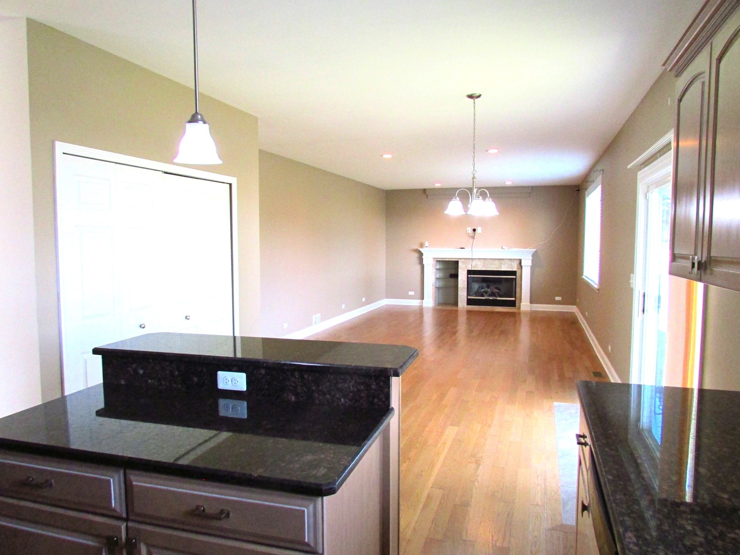 10123 Ashley Street Huntley, IL 60142 - Photo 5 of 33 a kitchen with stainless steel appliances granite countertop a stove a sink and a wooden floors