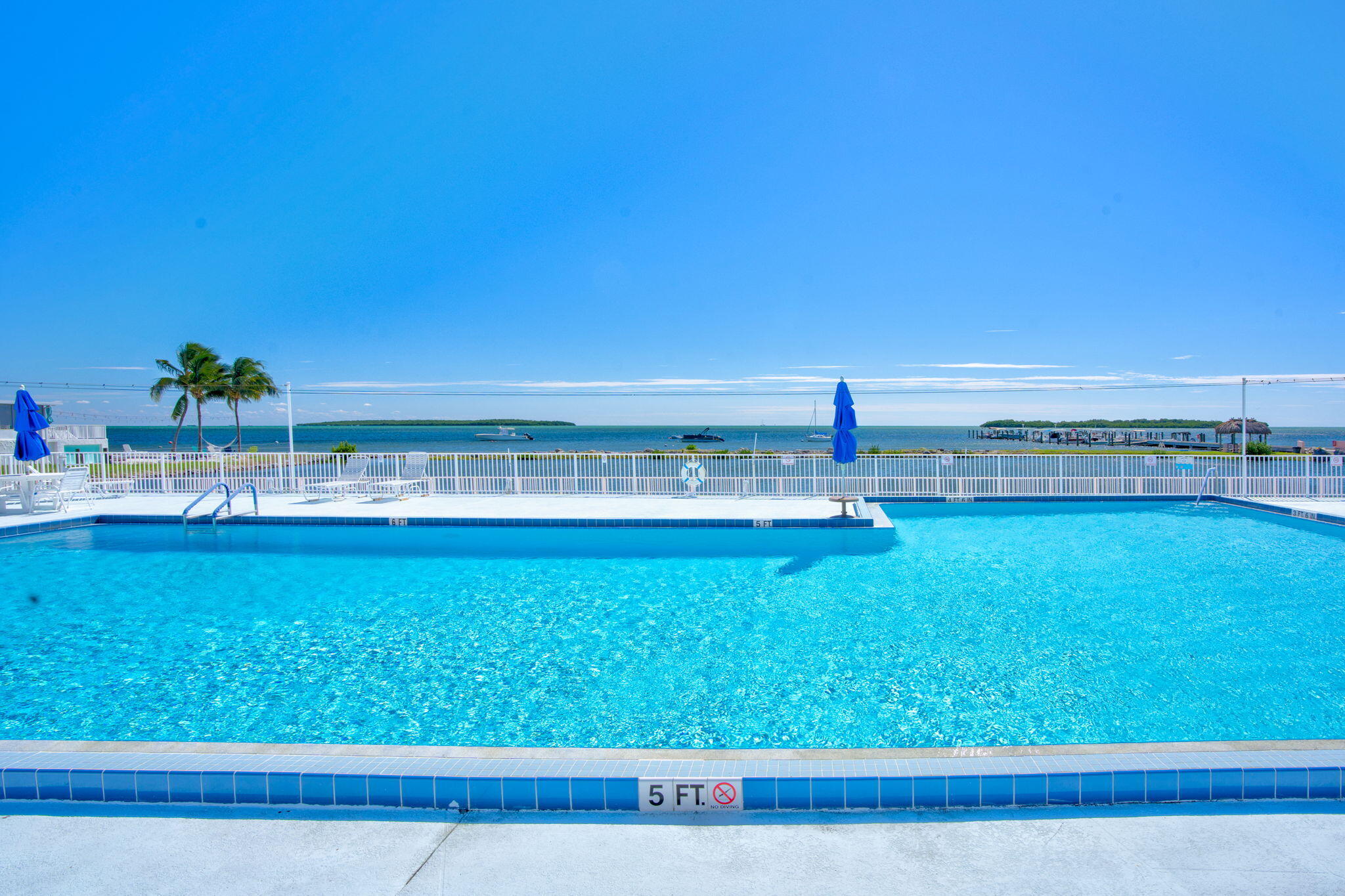 808 South Silver Circle Key Largo, FL 33037 - Photo 34 of 49 a view of a swimming pool with an outdoor space and seating area