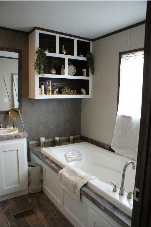 501 Mesquite Road San Marcos, TX 78666 - Photo 12 of 33 Bathroom with a garden tub, vanity, crown molding, and dark wood finished floors