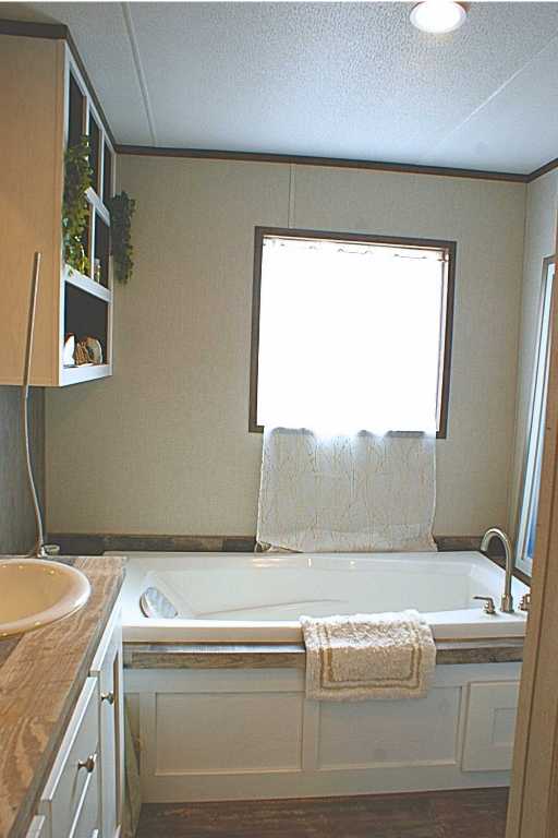 501 Mesquite Road San Marcos, TX 78666 - Photo 13 of 33 Full bathroom with a garden tub, vanity, a textured ceiling, and dark wood-style flooring
