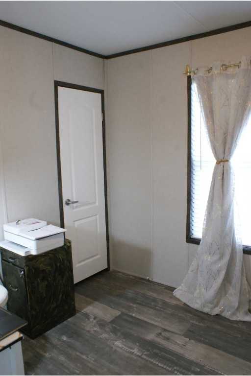 501 Mesquite Road San Marcos, TX 78666 - Photo 19 of 33 Bedroom featuring dark wood-type flooring, crown molding, and a closet