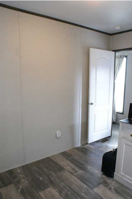 501 Mesquite Road San Marcos, TX 78666 - Photo 20 of 33 Unfurnished room with dark wood-style flooring and crown molding