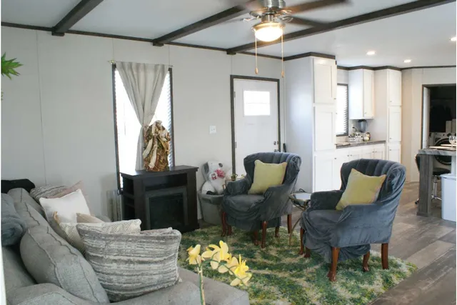 a living room with furniture and a chandelier