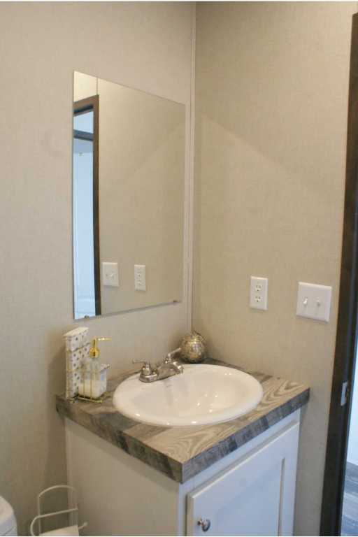 501 Mesquite Road San Marcos, TX 78666 - Photo 22 of 33 Half bath featuring vanity and toilet