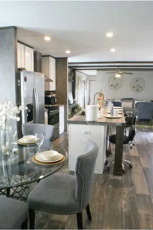 a kitchen with a table chairs stove and refrigerator