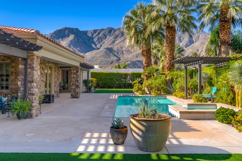 a view of swimming pool with outdoor seating and plants