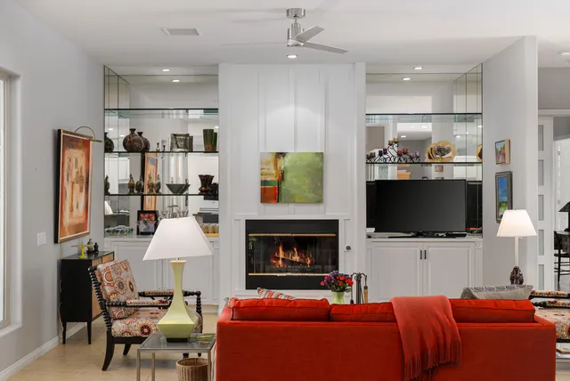 a bathroom with a large mirror and a shower
