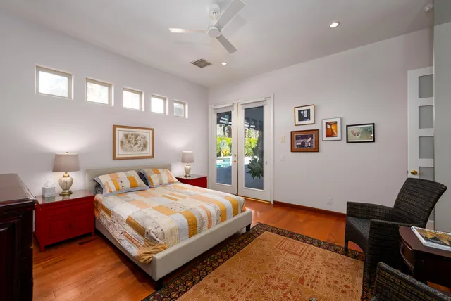 a living room with furniture a wooden floor and a flat screen tv