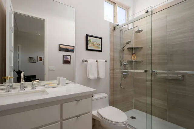 a bathroom with a sink toilet and shower