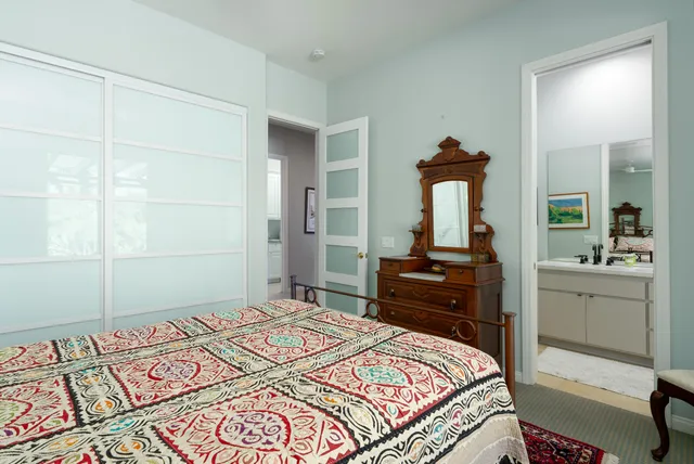a bathroom with a sink mirror and toilet