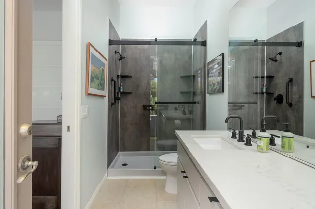 a view of a patio with chairs and floor to ceiling window with wooden fence