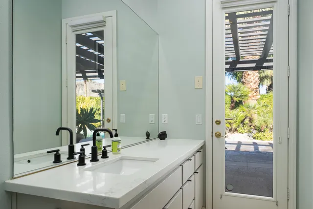 a view of backyard of house with green space