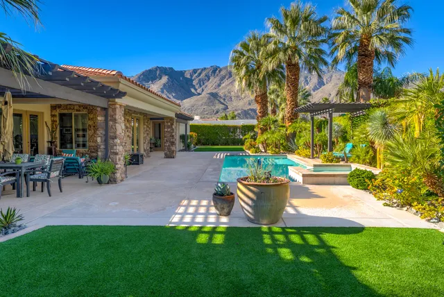 a view of a house with swimming pool and porch
