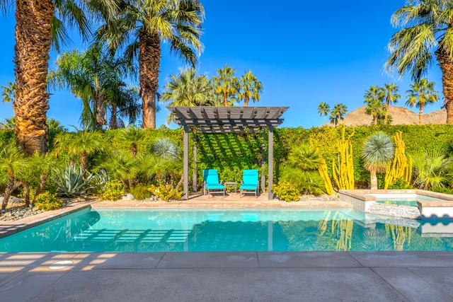 a view of a patio with a table and chairs under an umbrella