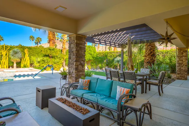 a view of a house with a yard and potted plants
