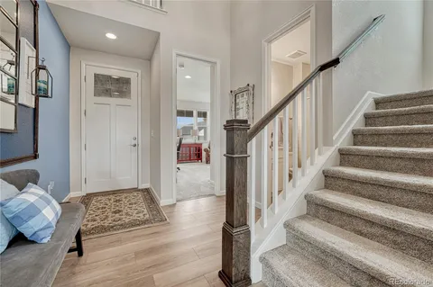 a kitchen with stainless steel appliances granite countertop a white cabinets and wooden floor