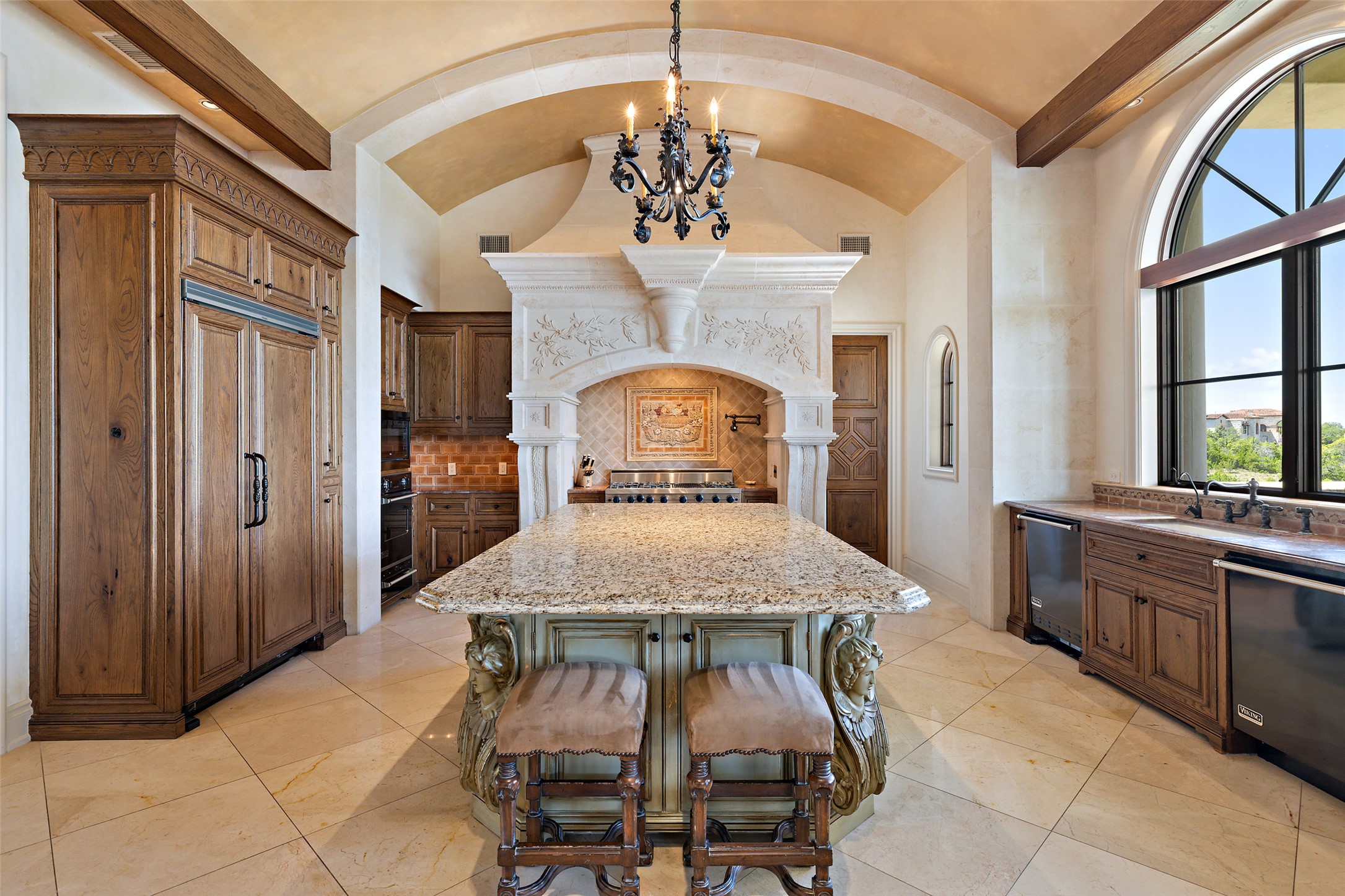 12821 Hughes Park Road Austin, TX 78732 - Photo 20 of 39 The gourmet chef's kitchen is a culinary masterpiece, equipped with Viking appliances, triple ovens, a built-in fridge, and a coffee machine.
